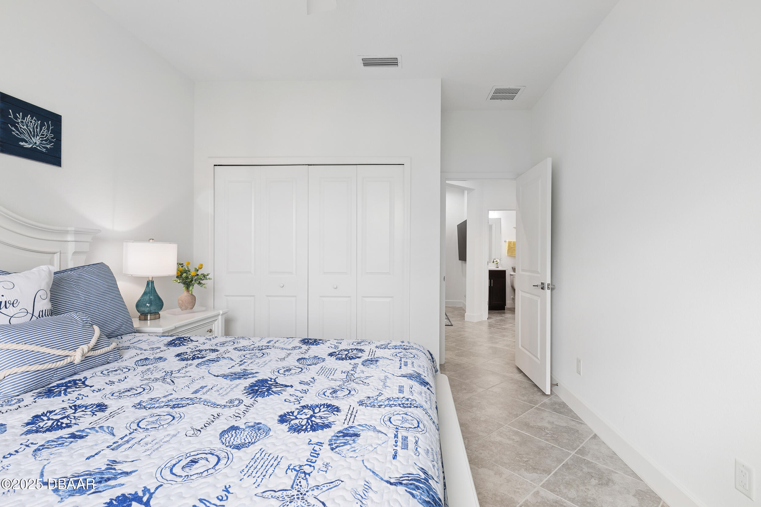208 Ocean Hammock Loop Daytona Beach, FL 32124 - Photo 28 of 91 a bedroom with a bed and chair
