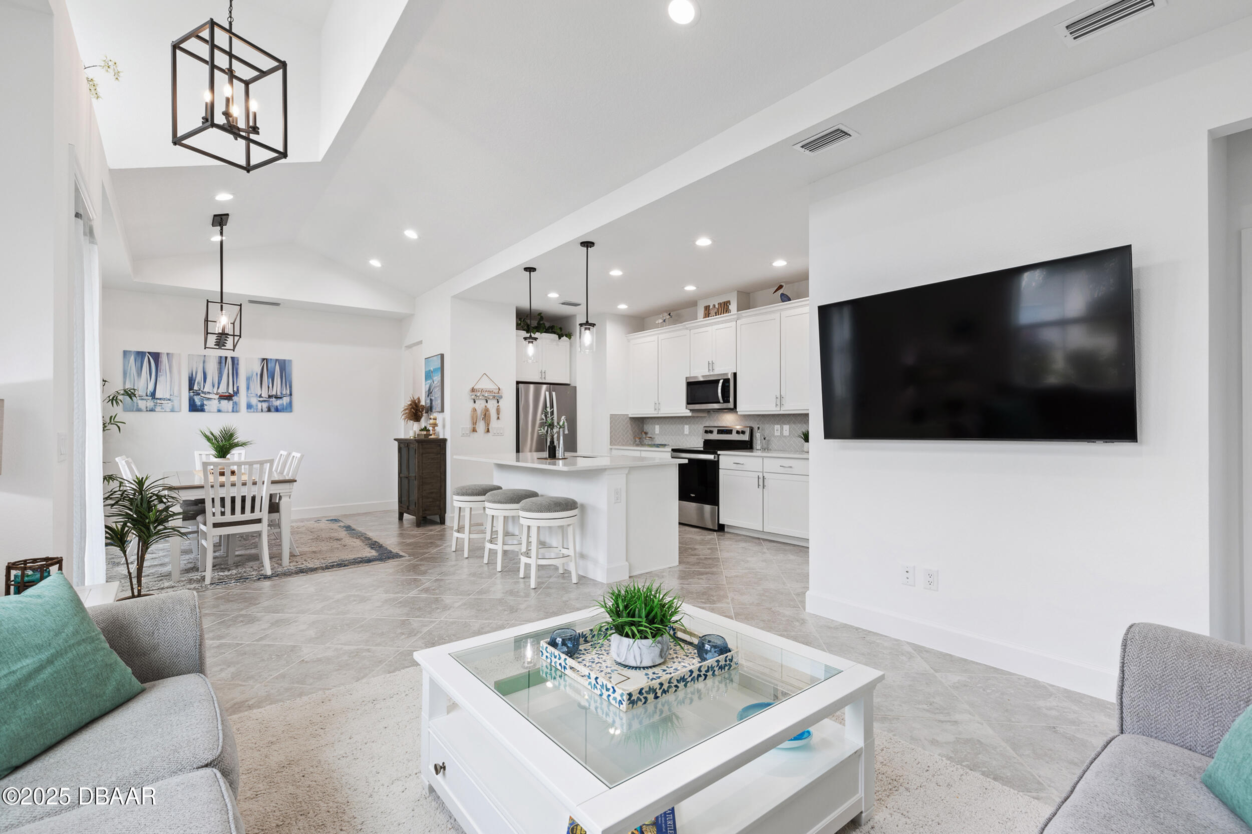 208 Ocean Hammock Loop Daytona Beach, FL 32124 - Photo 56 of 91 a living room with furniture a flat screen tv and kitchen view