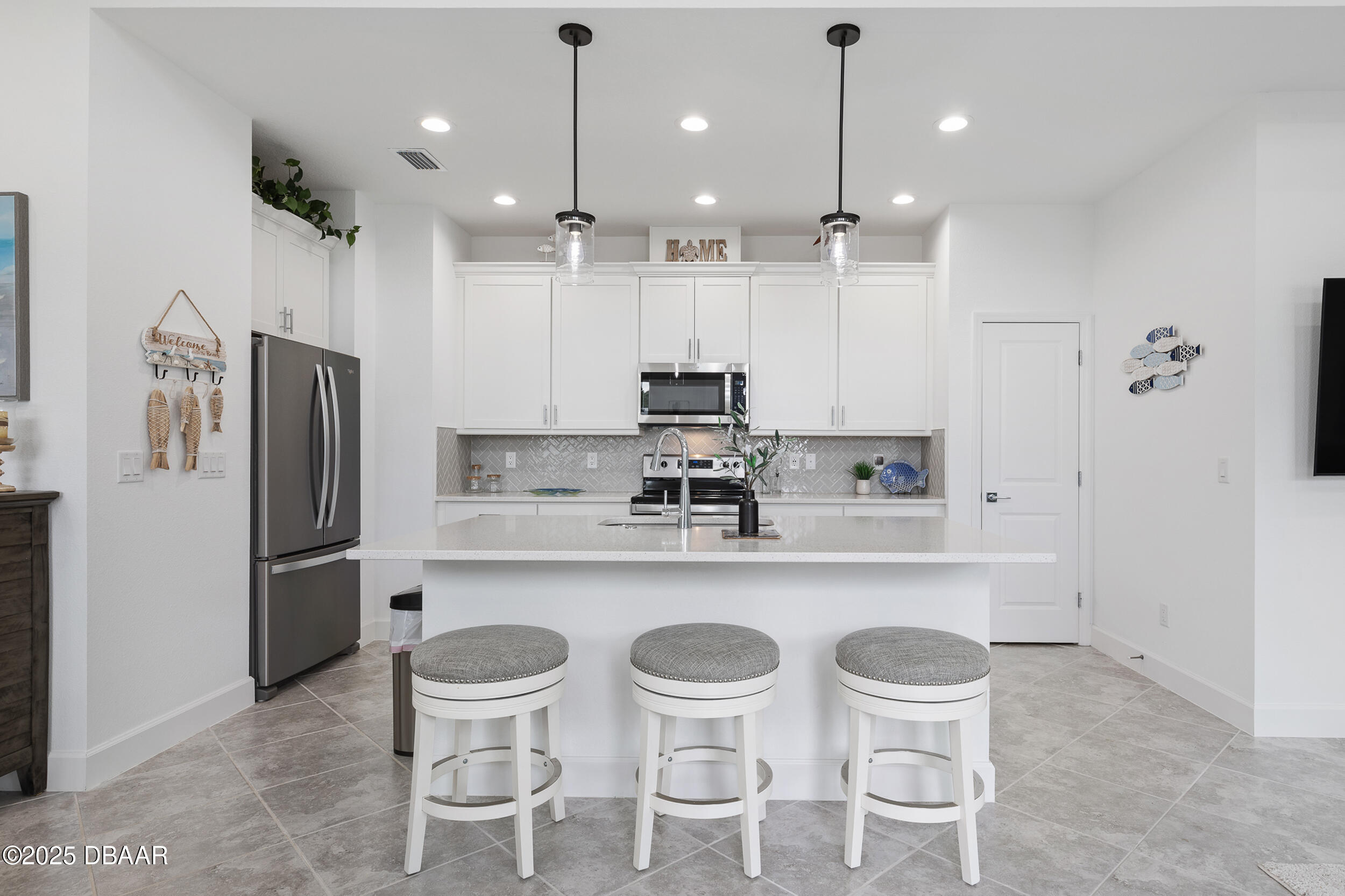 208 Ocean Hammock Loop Daytona Beach, FL 32124 - Photo 7 of 91 a kitchen with refrigerator and chairs