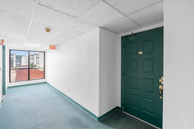 a view of hallway with window and stairs