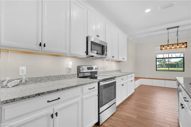 a kitchen with stainless steel appliances granite countertop wooden cabinets a sink and dishwasher