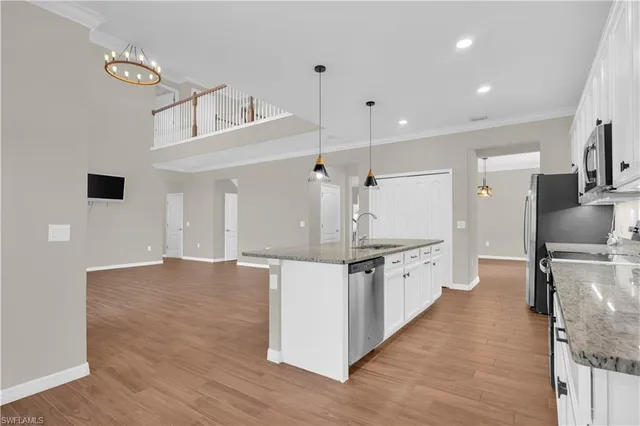 a kitchen with granite countertop a sink and a stove top oven