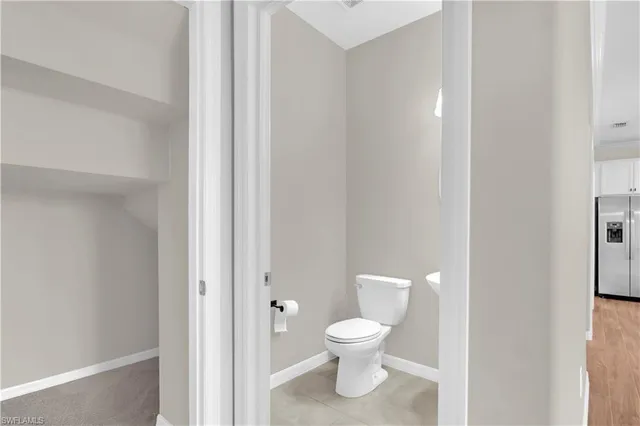 a white toilet sitting next to a bathroom sink