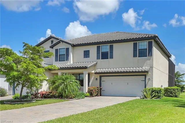 a front view of a house with a garden and plants
