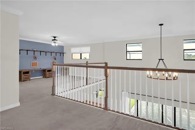 a view of a hallway with windows and stairs