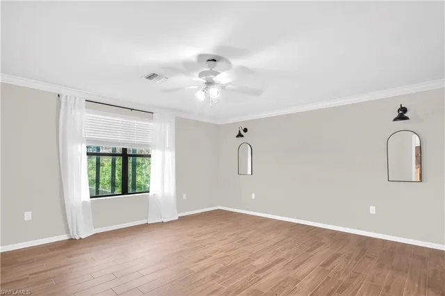 wooden floor in an empty room with a window