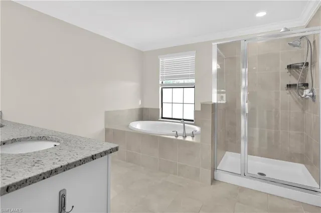 a bathroom with a granite countertop sink a toilet and shower