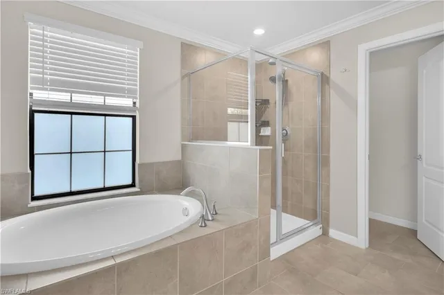 a bathroom with a tub and shower