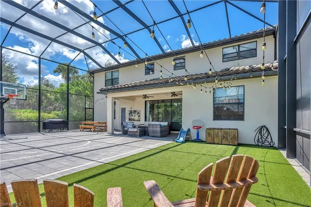a patio with a table and chairs and a barbeque