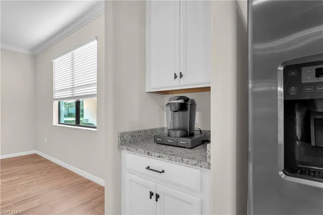 a kitchen with cabinets and window