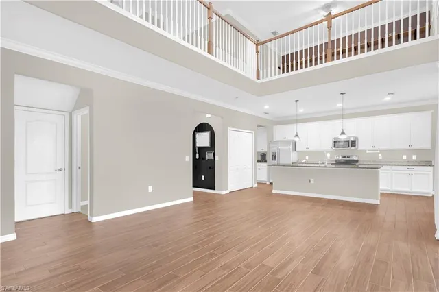 a view of kitchen with granite countertop cabinets and wooden floor