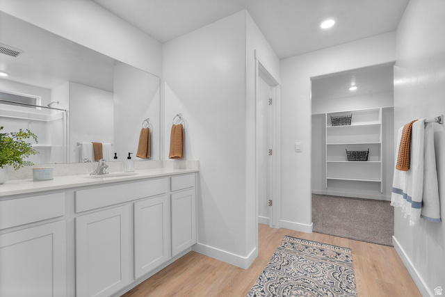722 West 2840 South, Unit 8 Logan, UT 84321 - Photo 22 of 23 Bathroom featuring recessed lighting, vanity, light wood-style flooring, and a spacious closet