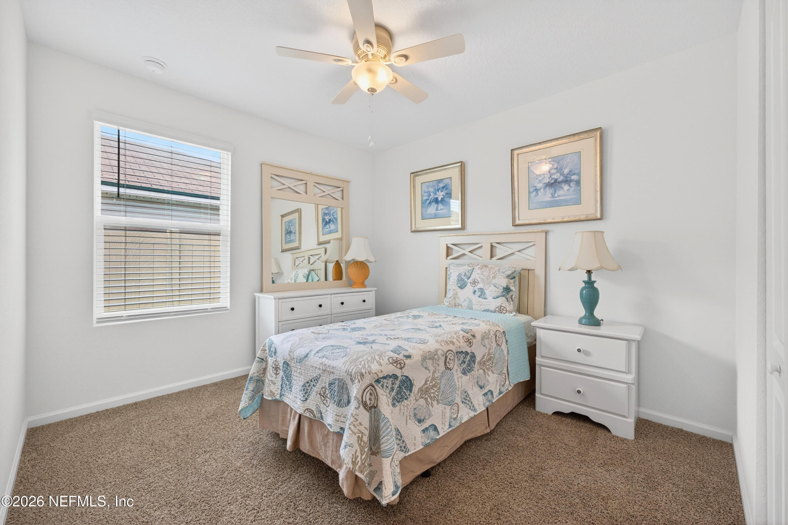 231 Encanto Way Street St. Augustine, FL 32084 - Photo 16 of 36 a bedroom with a bed and a window