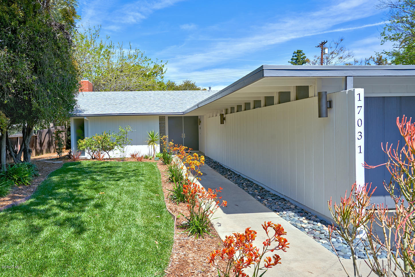 17031 Labrador Street Northridge, CA 91325 - Photo 1 of 20 a front view of a house with garden