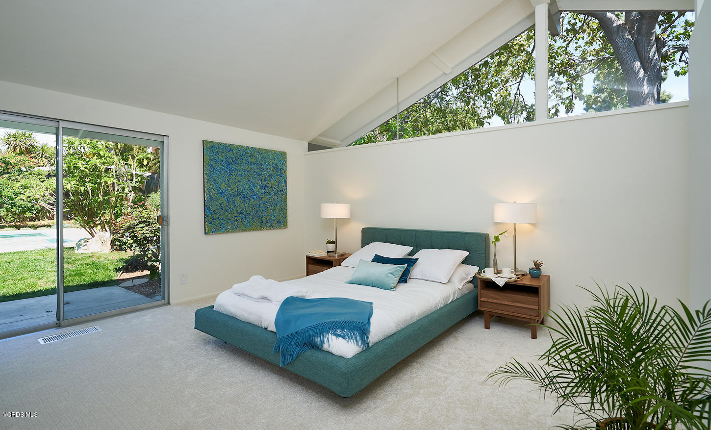 17031 Labrador Street Northridge, CA 91325 - Photo 13 of 20 a bedroom with a bed lamp and window