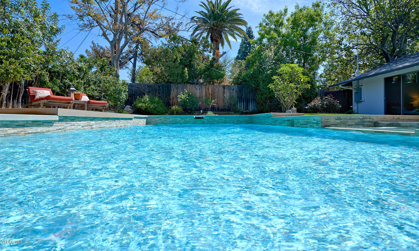 17031 Labrador Street Northridge, CA 91325 - Photo 15 of 20 a view of a backyard with a garden and trees
