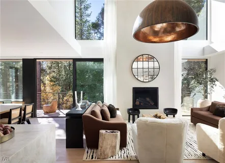 a living room with fireplace furniture and a large window