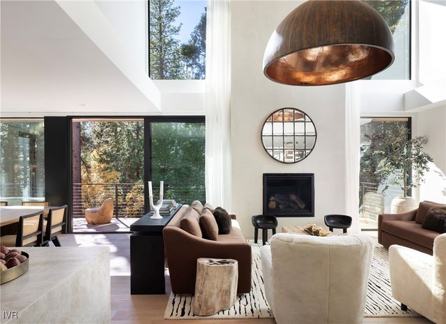 a living room with fireplace furniture and a large window