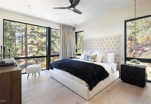 a spacious bedroom with a bed and a large window