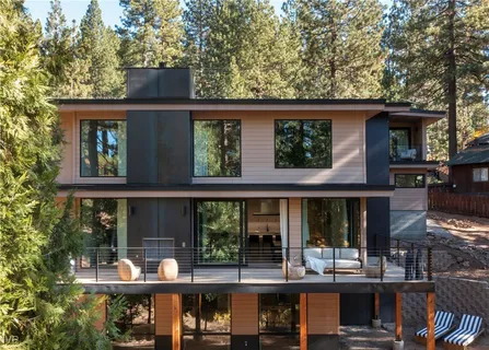 a front view of a house with porch and outdoor seating