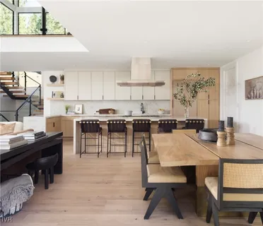 a view of kitchen with cabinets table and chairs
