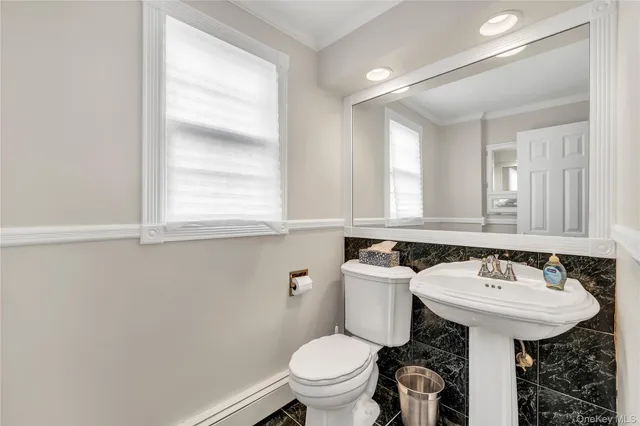a bathroom with a sink toilet and a mirror