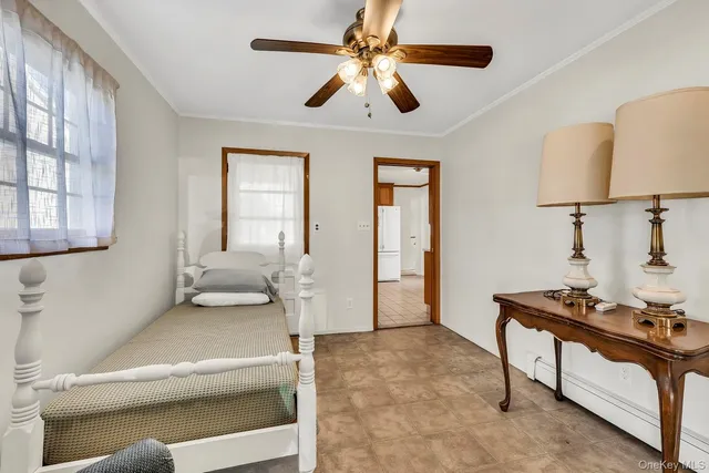 a living room with furniture and a ceiling fan