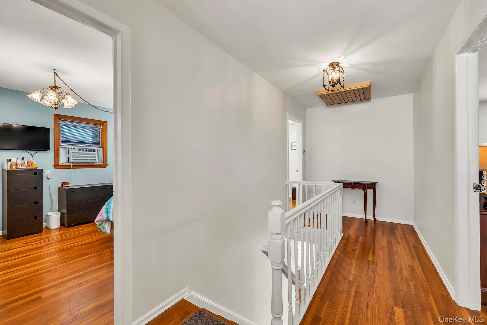 155 Fairview Road Farmingdale, NY 11735 - Photo 13 of 23 a view of a hallway with wooden floor and staircase