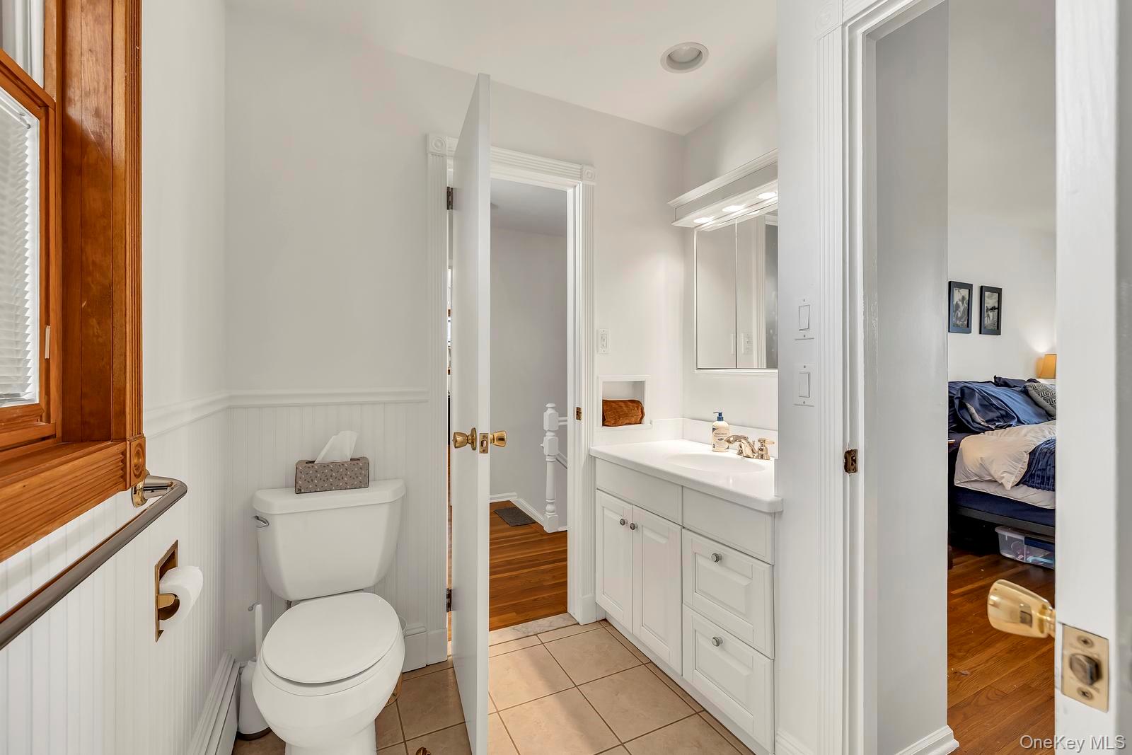 155 Fairview Road Farmingdale, NY 11735 - Photo 17 of 23 a bathroom with a toilet a sink and a mirror