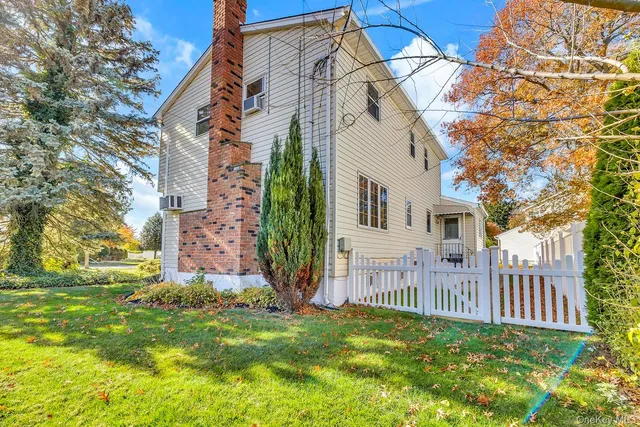 a view of a house with a yard and pathway