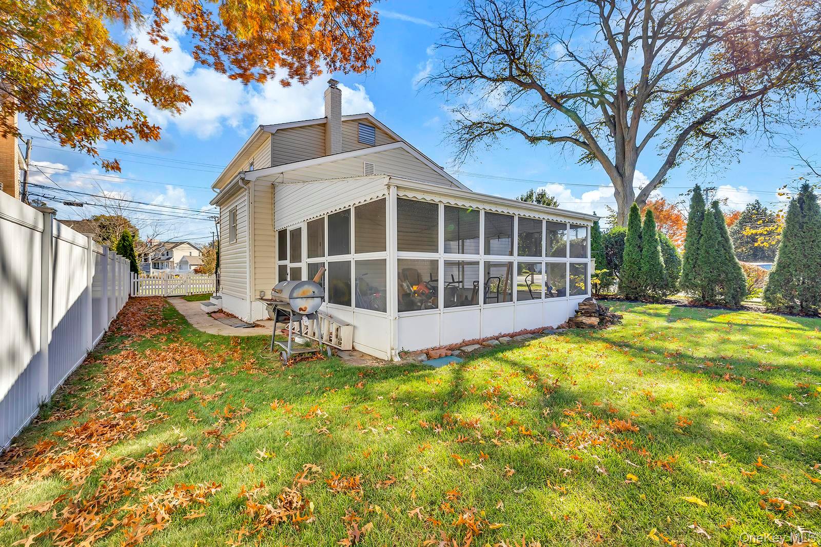 155 Fairview Road Farmingdale, NY 11735 - Photo 22 of 23 a view of a house with a large tree and a yard with swimming pool