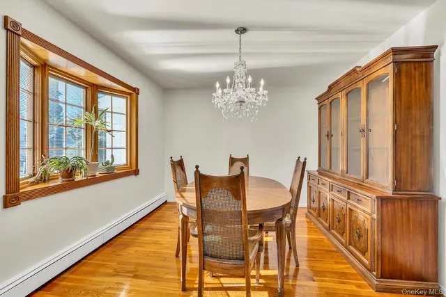 a view of a dining room with furniture and chandelier