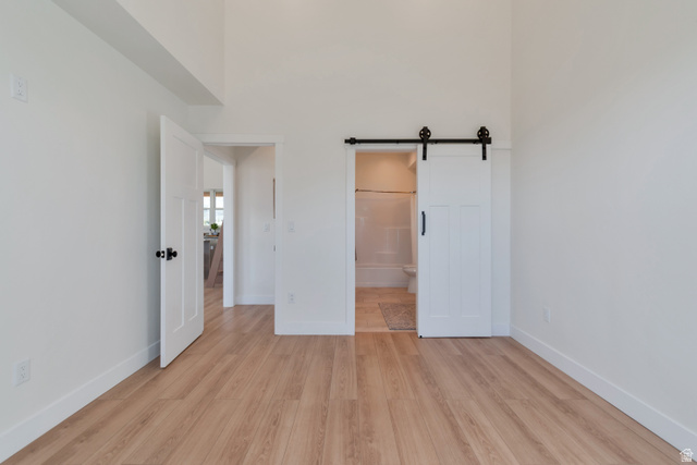1820 West Farmhouse Flats Road Peoa, UT 84061 - Photo 70 of 79 Vaulted ceilings frame this space, featuring wood-finish flooring and crisp white walls