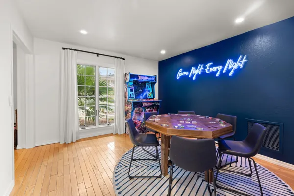 a spacious bedroom with a large bed and a flat tv screen on dresser