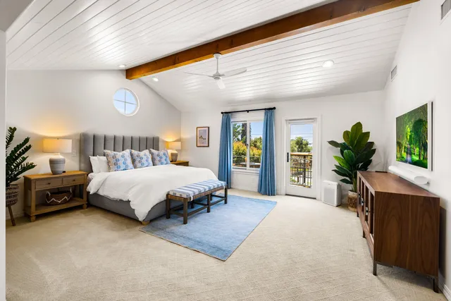 a bedroom with furniture and a flat screen tv