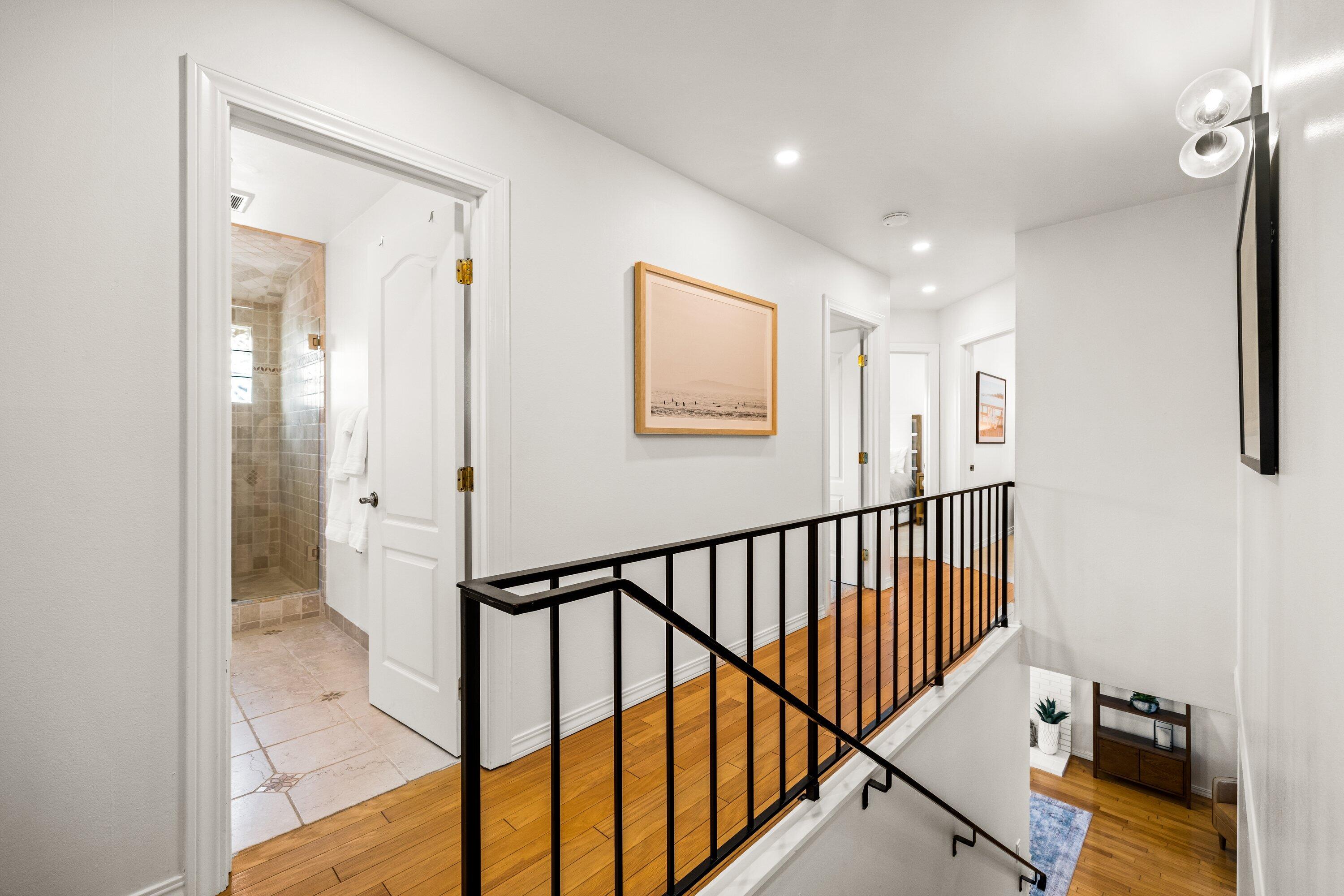 5329 University Drive Santa Barbara, CA 93111 - Photo 25 of 51 a view of a hallway with wooden floor and a bathroom