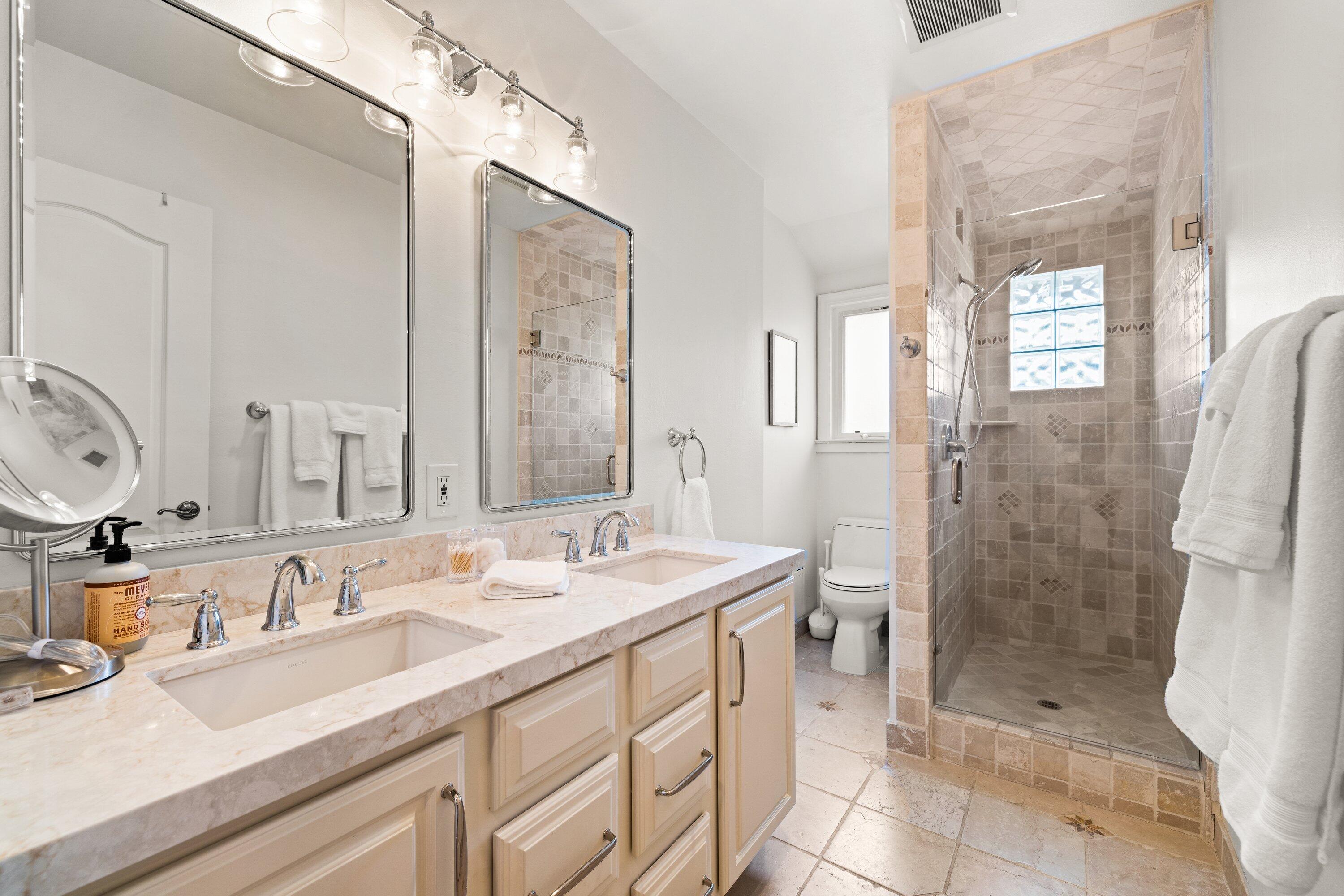 5329 University Drive Santa Barbara, CA 93111 - Photo 26 of 51 a bathroom with a double vanity sink mirror double shower and a bathtub