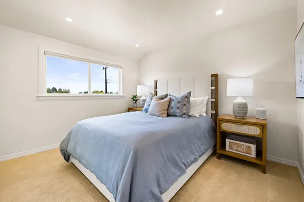 a bedroom with a bed and a window