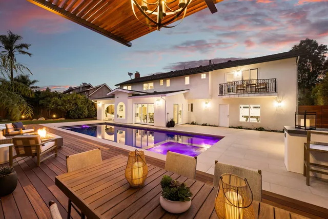 a view of deck with seating area and trees