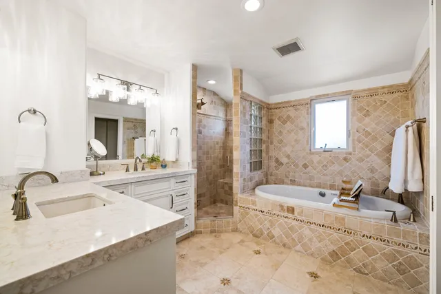a bathroom with a tub and a sink