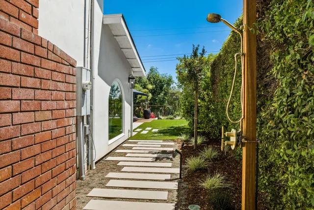 a view of house with yard and entertaining space