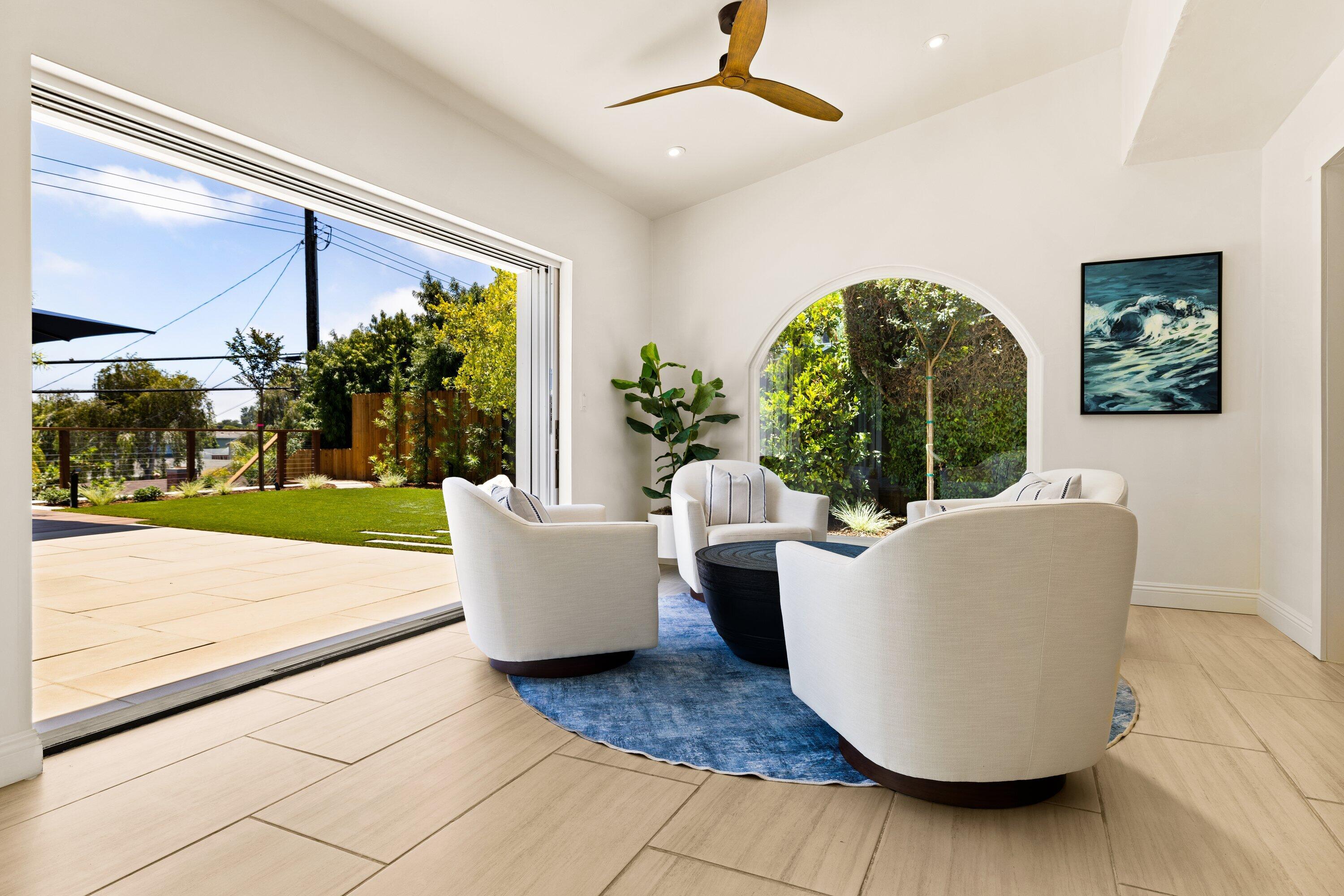 5329 University Drive Santa Barbara, CA 93111 - Photo 8 of 51 a living room with a couch and a floor to ceiling window