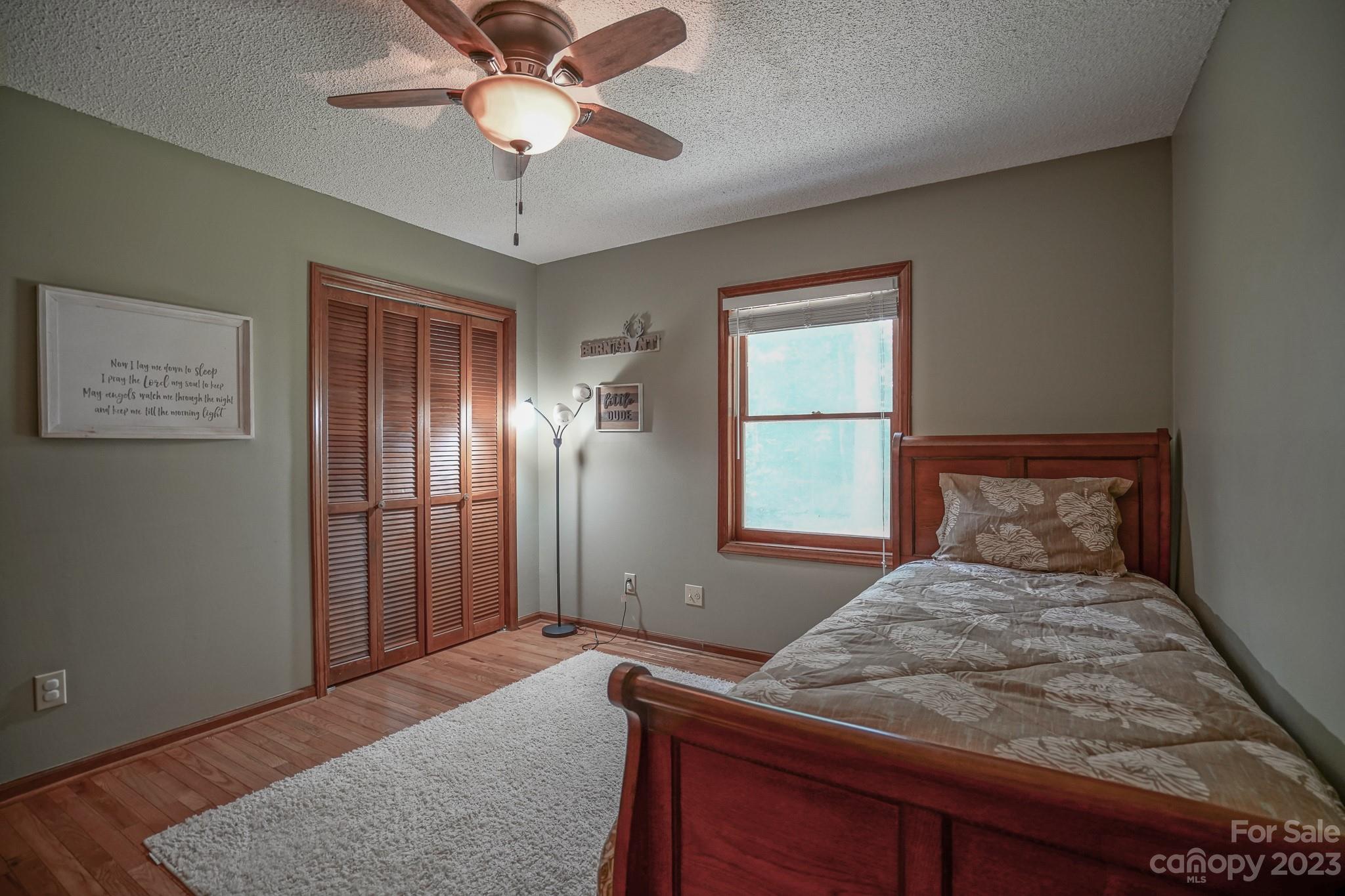 2743 Harmony Highway Harmony, NC 28634 - Photo 19 of 47 a bedroom with a bed and a chandelier