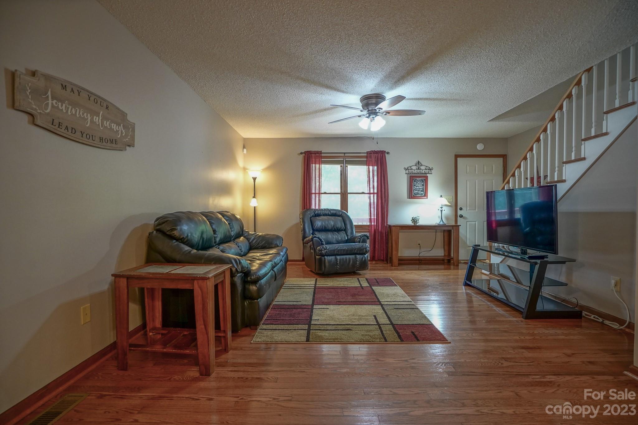 2743 Harmony Highway Harmony, NC 28634 - Photo 23 of 47 a living room with furniture a fireplace and a flat screen tv