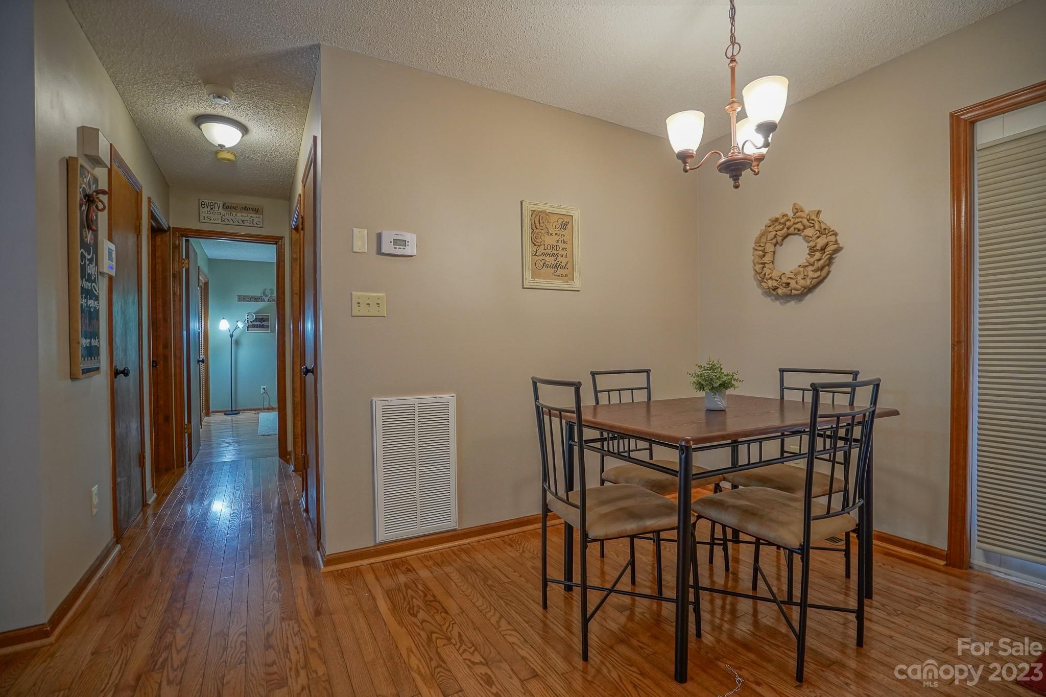 2743 Harmony Highway Harmony, NC 28634 - Photo 28 of 47 a view of a dining room with furniture and wooden floor