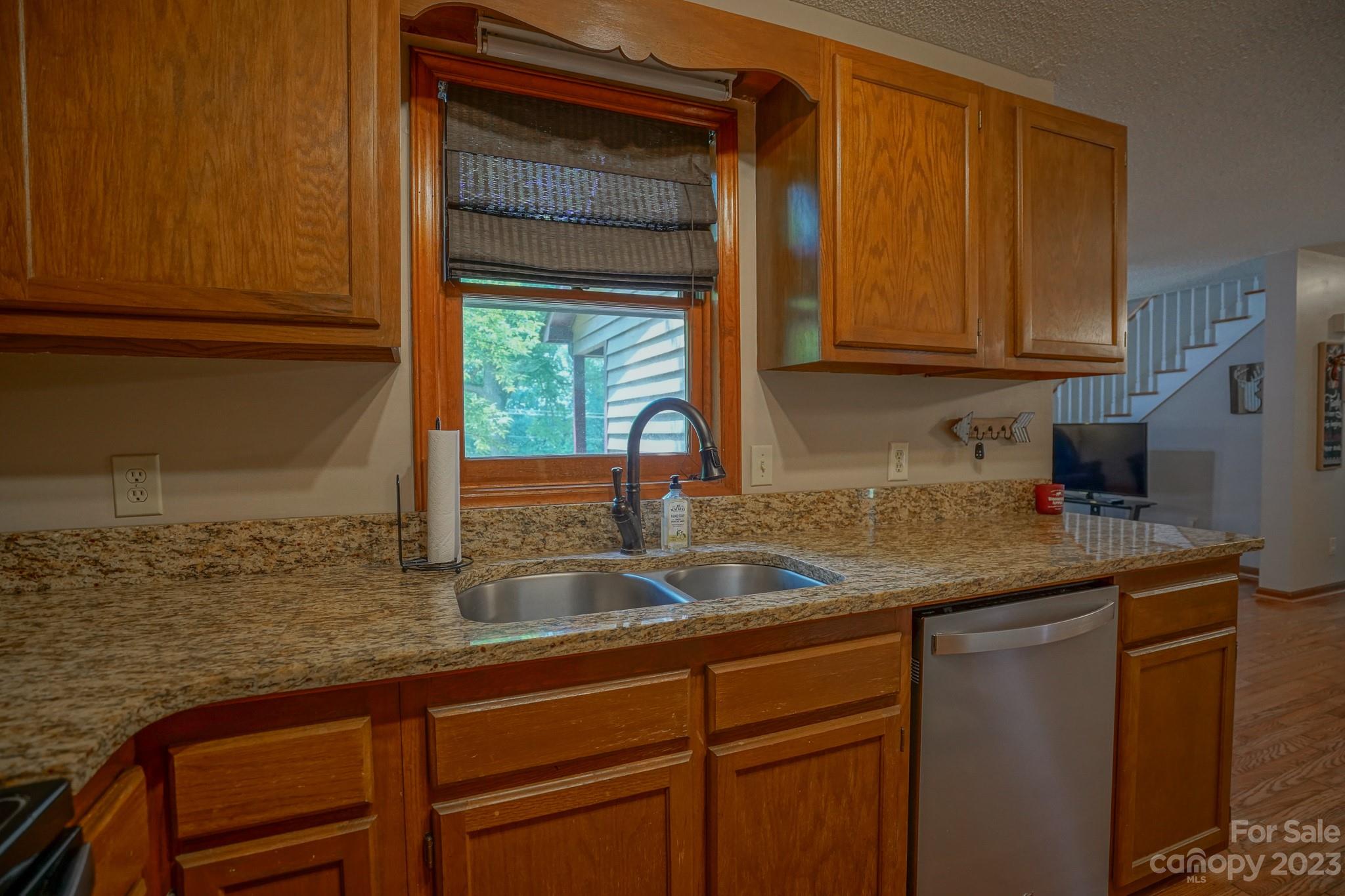 2743 Harmony Highway Harmony, NC 28634 - Photo 32 of 47 a kitchen with granite countertop stainless steel appliances a sink and cabinets