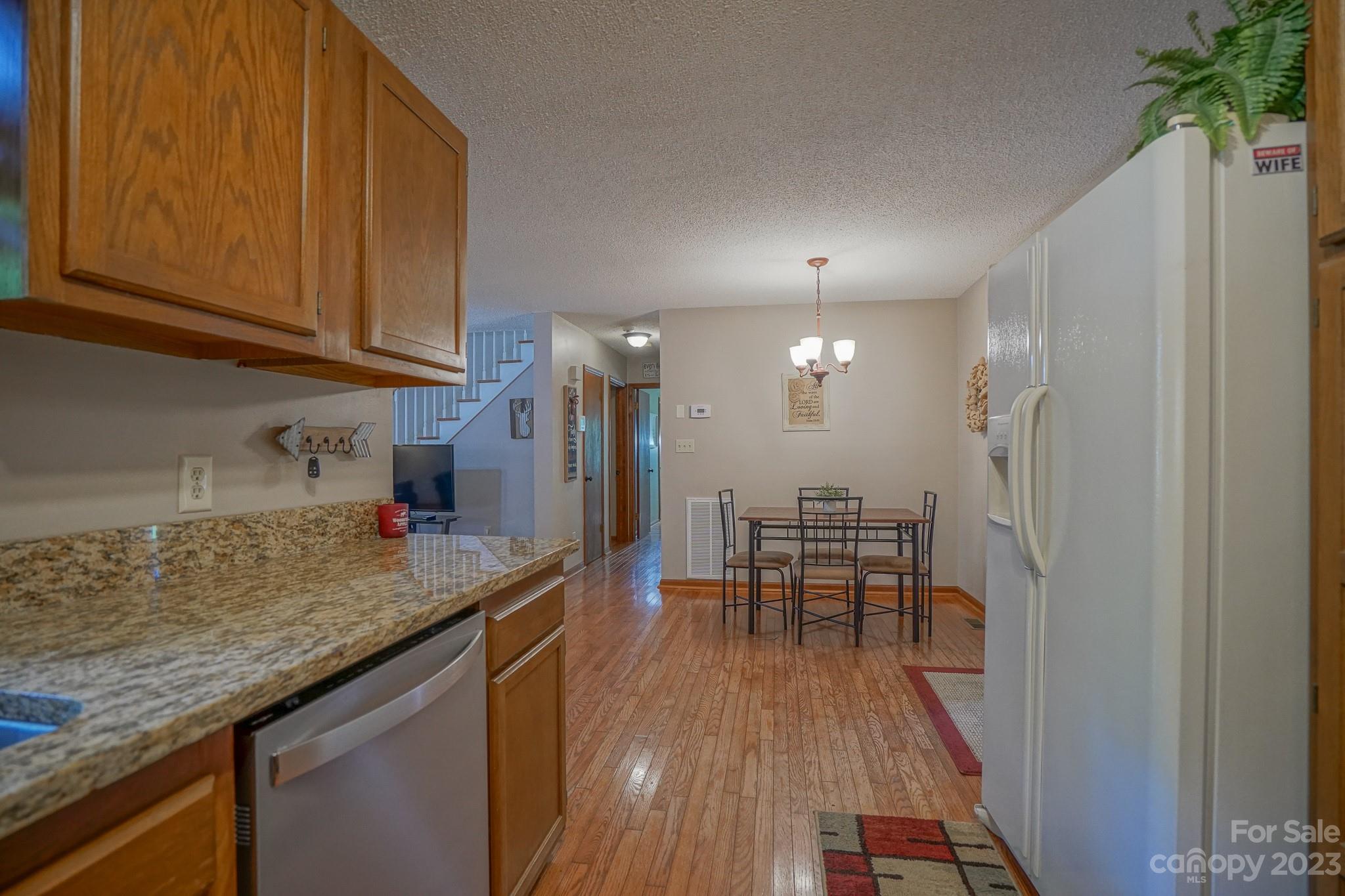 2743 Harmony Highway Harmony, NC 28634 - Photo 33 of 47 a view of a kitchen with dining room and wooden floor