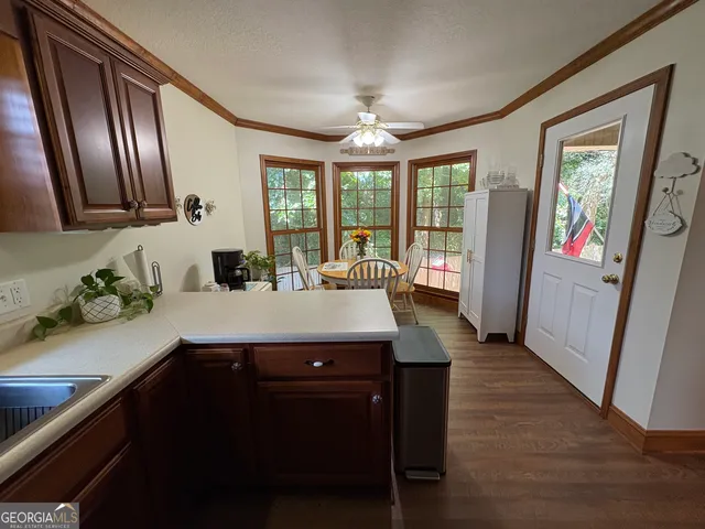 a kitchen with sink and large windows