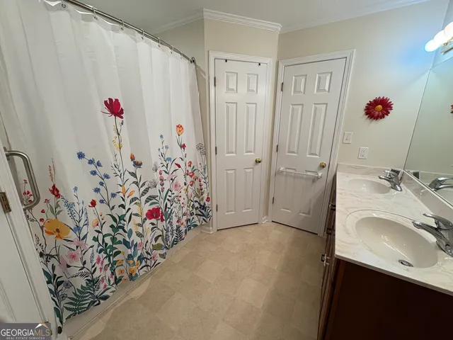 a bathroom with a shower and a sink