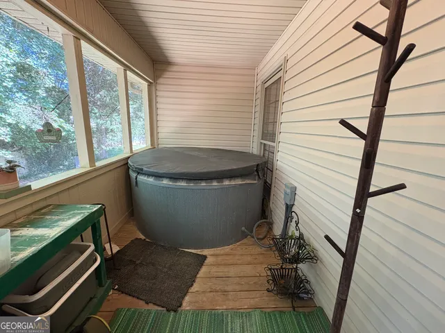 a view of a balcony with chairs and wooden floor